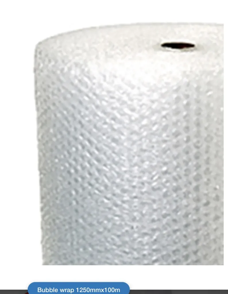 A large, upright roll of clear plastic bubble wrap. The roll is tightly wound, showing a dense pattern of small, air-filled circular bubbles. Typically used to protect fragile items when moving.