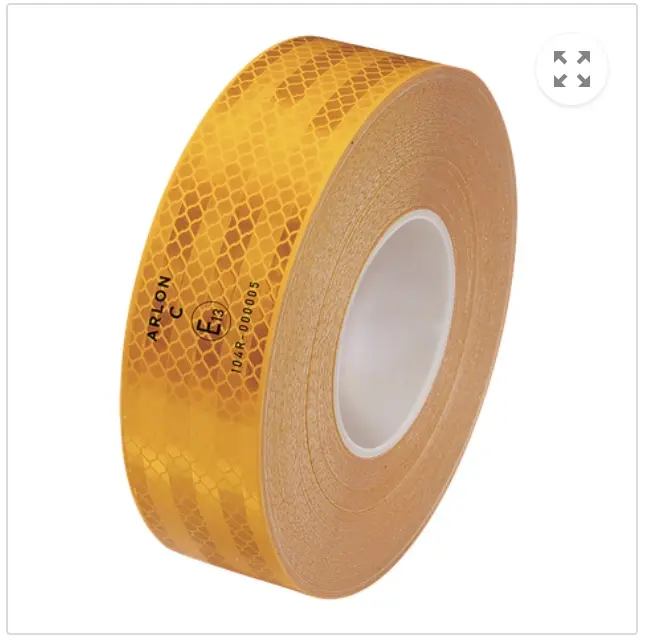 A heavy-duty truck trailer honeycomb reflective tape applied along the bottom edge to meet DOT safety standards